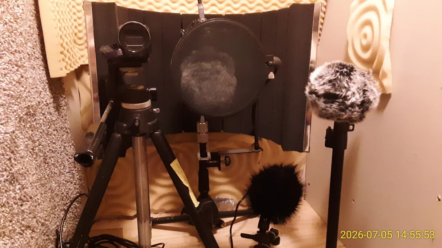 A collection of microphones on various stands. In the back, is the permanently set-up AT2020 I use as a "studio mic" for voiceover/voice-acting, on the left is the Canon Vixia video camera I've been using for videologs. At bottom is the new shotgun mic I was using for outdoor recording, and at upper left is the Zoom H5 mic/recorder that I use for field recordings. I also set up my Samsung Galaxy phone for this, but of course, I used it to take this picture.